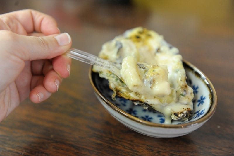 Japan's Miyajima Island baked oyster with macaroni and cheese. Travel post on "Best Thing I Ever Ate" by Mikkel Paige of Sometimes Home travel blog.