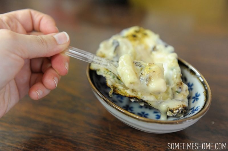 Best Thing I Ever Ate by Sometimes Home travel blog. Photos of a macaroni and cheese baked oyster in Miyajima Island, Japan.