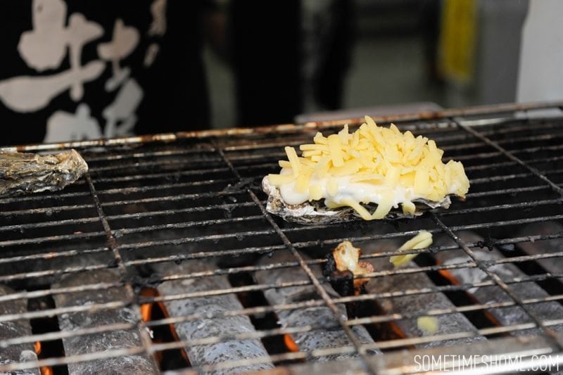 Best Thing I Ever Ate by Sometimes Home travel blog. Photos of a macaroni and cheese baked oyster in Miyajima Island, Japan.