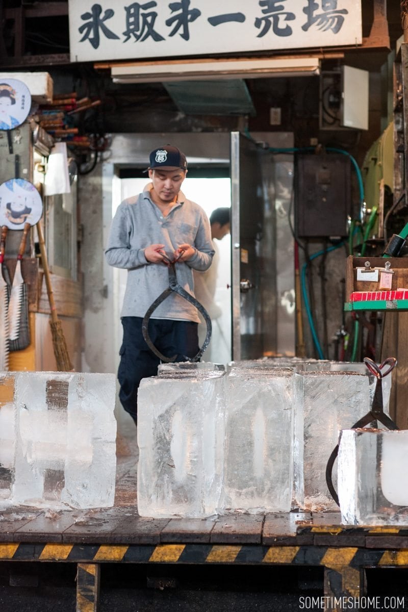 Experience and photos at Tsukiji Fish Market in Tokyo, Japan by Sometimes Home Travel Blog. Picture of a vendor moving huge blocks of ice.