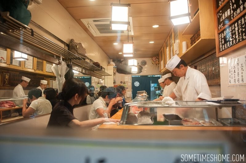 Sushi Dai Restaurant at Tsukiji Fish Market in Tokyo Japan. Photos on Sometimes Home travel blog with the counter service inside a small restaurant.