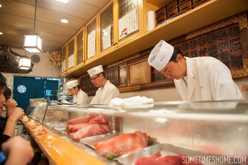 Sushi Dai Restaurant at Tsukiji Fish Market in Tokyo Japan. Photos on Sometimes Home travel blog with the counter service inside a small restaurant.