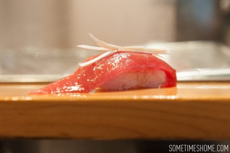 Sushi Dai Restaurant at Tsukiji Fish Market in Tokyo Japan. Photos on Sometimes Home travel blog with a picture of a tuna sushi piece.