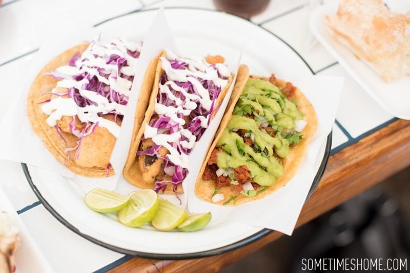 Travel photos and ideas in Tijauna, Mexico with hipster spot Telefonica Gastropark food truck hotspot on Sometimes Home blog. Tacos image with various vegetarian options.