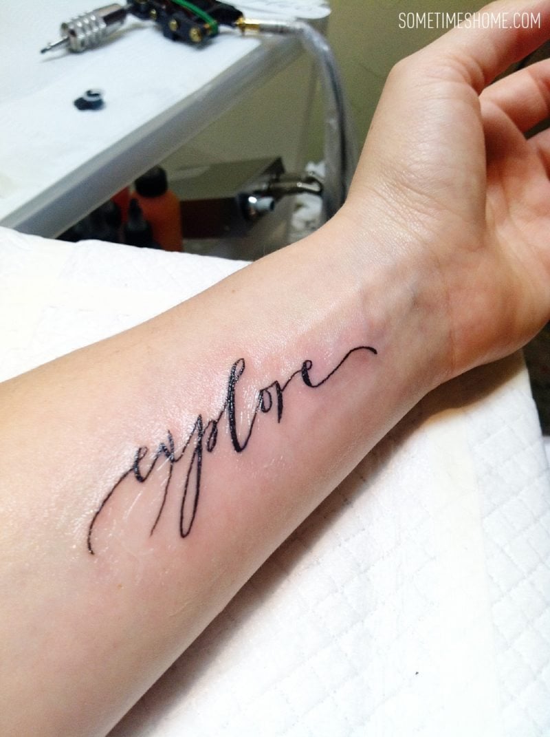 The best travel tattoo post by Sometimes Home travel blog, with "Explore" in hand written calligraphy. Right after it had been inked on the forearm in Osaka, Japan.