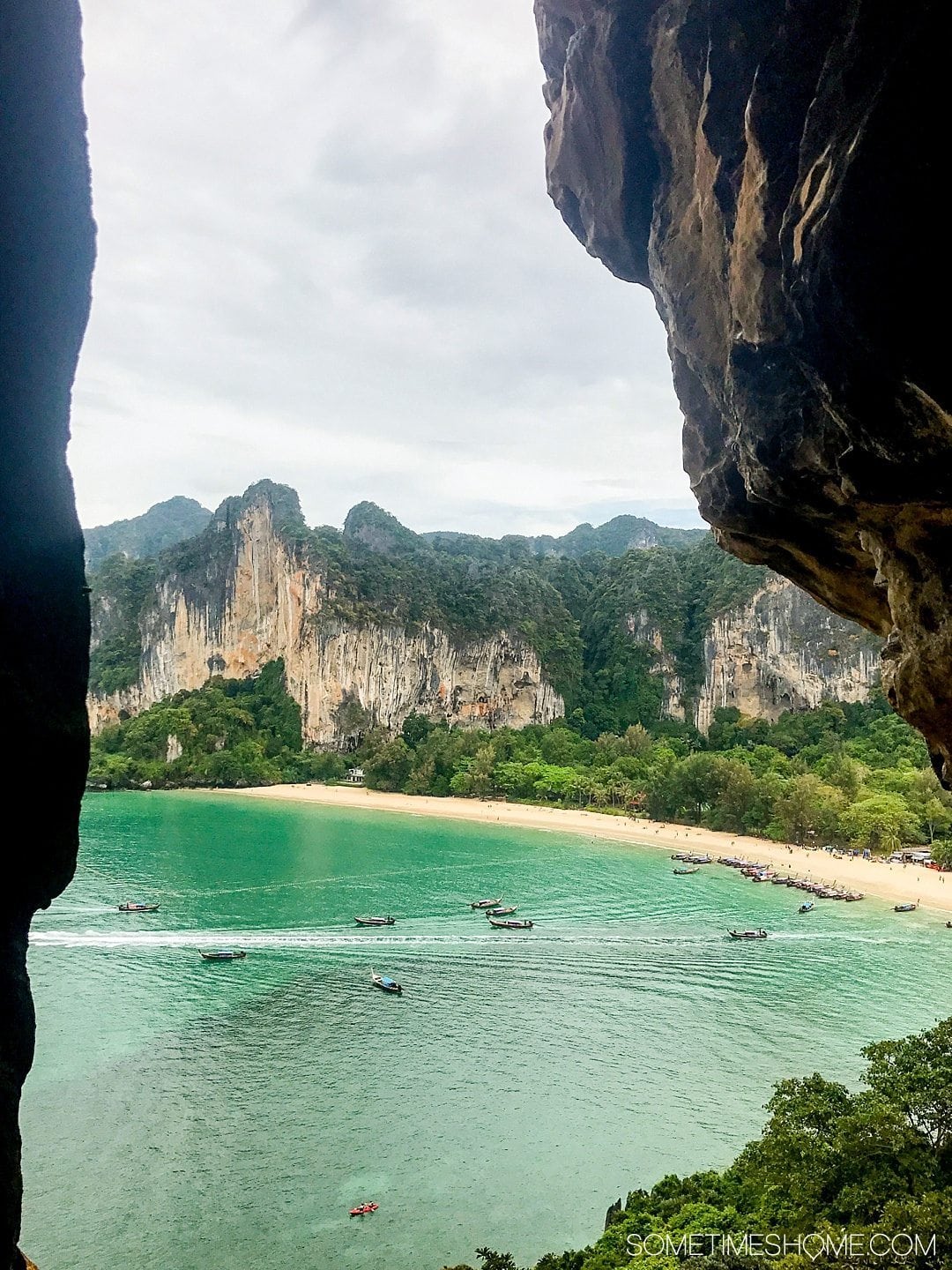 The BEST excursion we did in Thailand was a day rock climbing Phuket with an amazing guide. Our destinations were Krabi and Railay Beach on our day trip itinerary. Our adventure between the islands was a wonderful thing to do on a mid-size budget. Learn about our cost (for solo and couples) and see photography and more on Sometimes Home. #ThailandTravel #PhuketThailand #RailayBeach #KrabiBeach #RockClimbing #ThailandRockClimbing #ThingstodoinPhuket #ThaiBeaches #SoutheastAsiaTrip #RockClimbingThailand