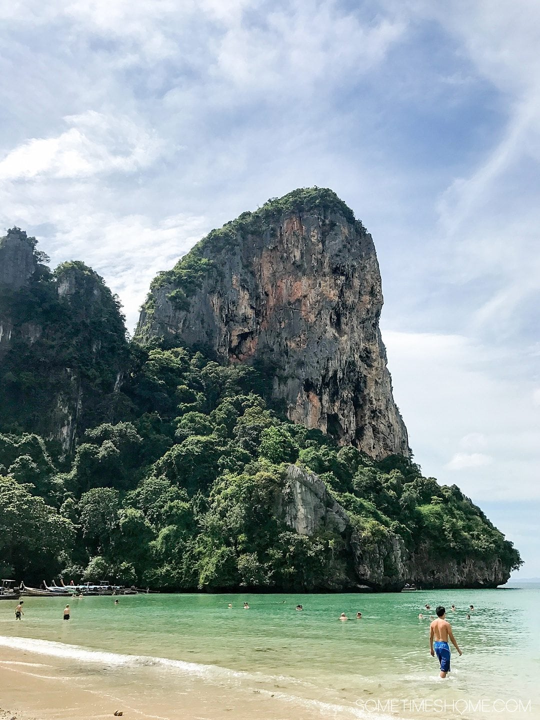 The BEST excursion we did in Thailand was a day rock climbing Phuket with an amazing guide. Our destinations were Krabi and Railay Beach on our day trip itinerary. Our adventure between the islands was a wonderful thing to do on a mid-size budget. Learn about our cost (for solo and couples) and see photography and more on Sometimes Home. #ThailandTravel #PhuketThailand #RailayBeach #KrabiBeach #RockClimbing #ThailandRockClimbing #ThingstodoinPhuket #ThaiBeaches #SoutheastAsiaTrip #RockClimbingThailand