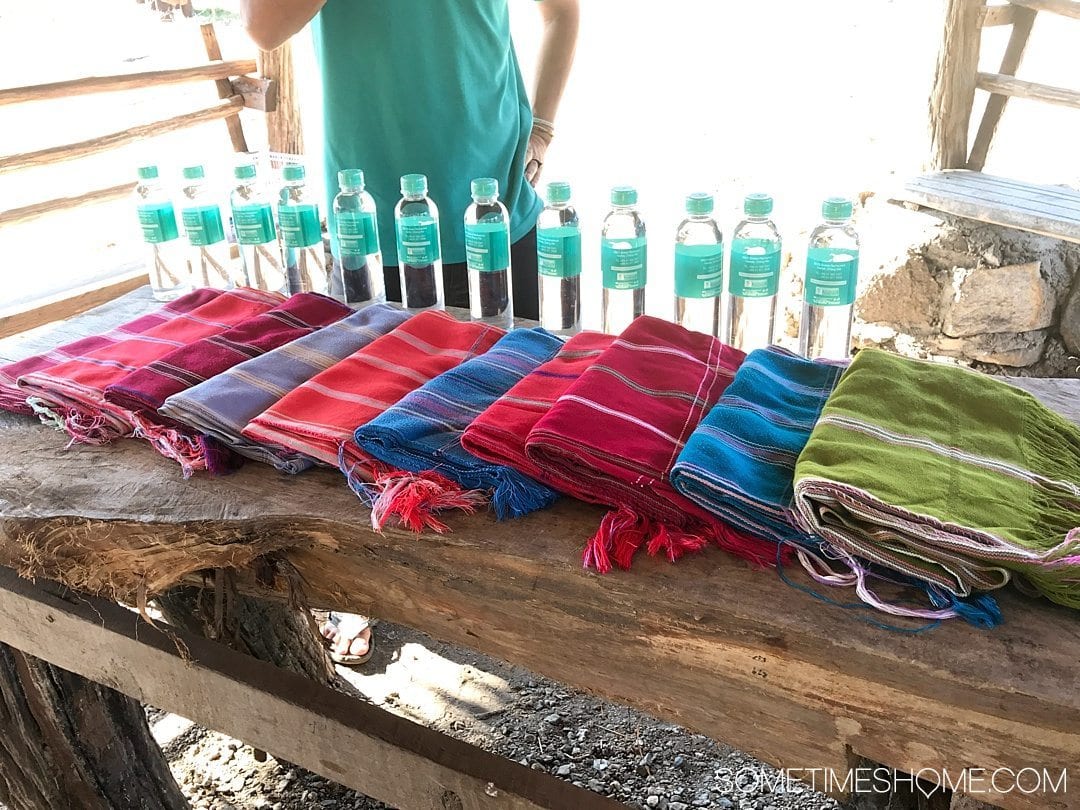 Vital FAQs Answered About Patara Elephant Farm in Chiang Mai. Information by Sometimes Home travel blog. A photo of their custom branded water bottles and cloth shirts and pants worn on the elephants.