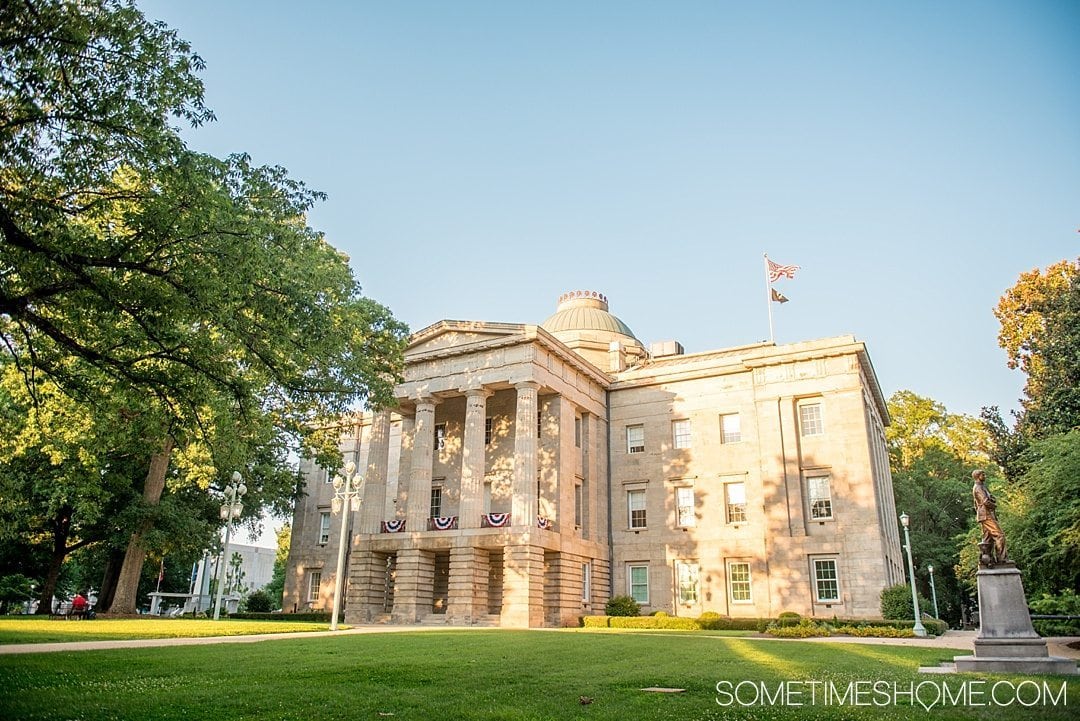 10 Best Downtown Raleigh Photography Spots on Sometimes Home travel blog. Photo of the Capital Building during golden hour.