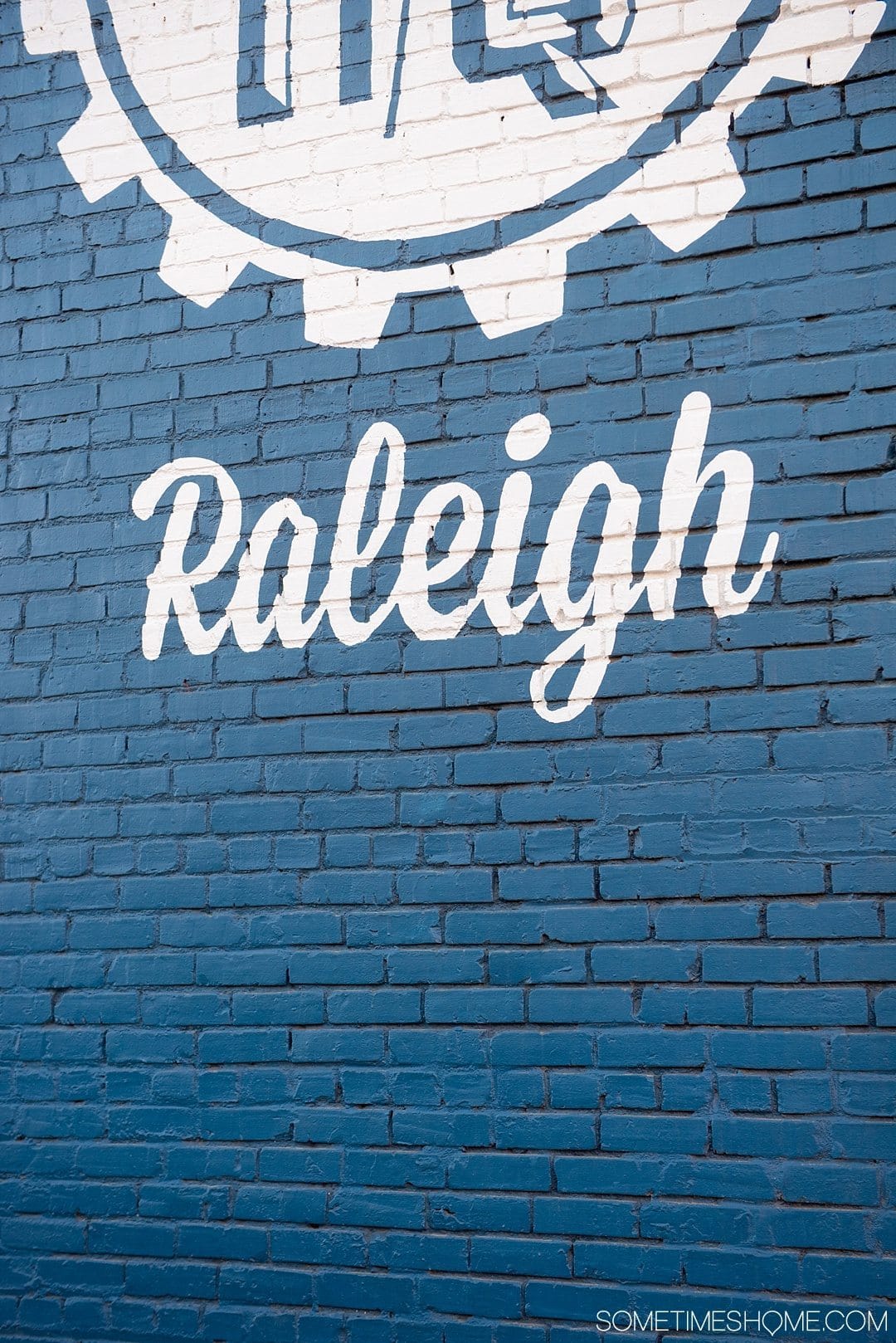 10 Best Downtown Raleigh Photography Spots on Sometimes Home travel blog. Photo of HQ Raleigh's blue mural wall.