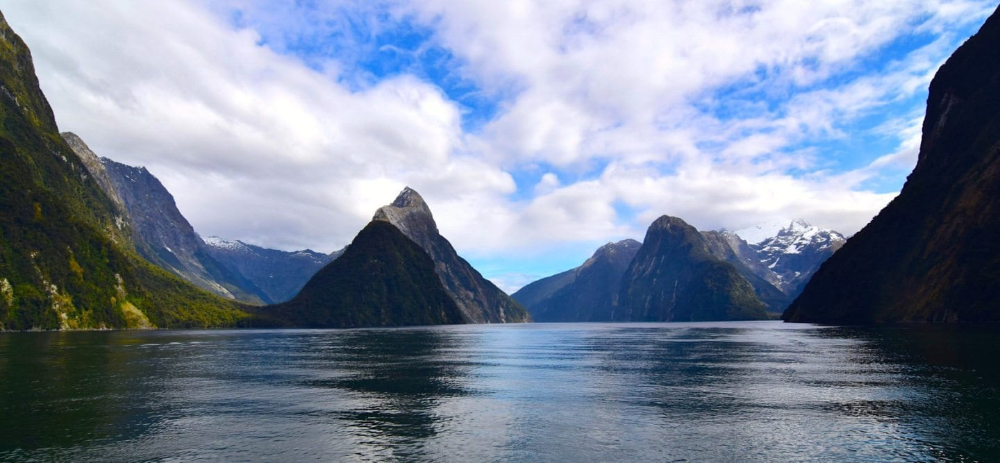 Fantastic Fall Destination Ideas Around the World on Sometimes Home travel blog. Picture of Milford Sound, New Zealand by Positive Impact Podcast.