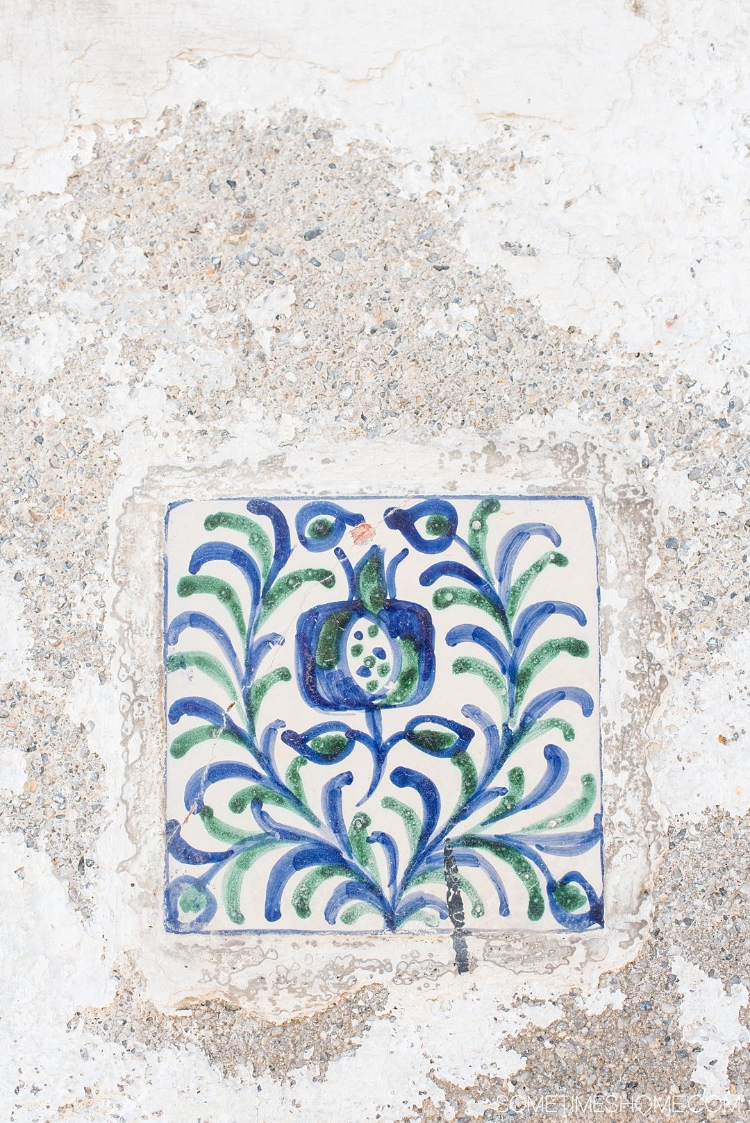 One Perfect Day in Granada Spain. Photos and itinerary on Sometimes Home travel blog. Picture of pomegranate design on hand painted tile. 