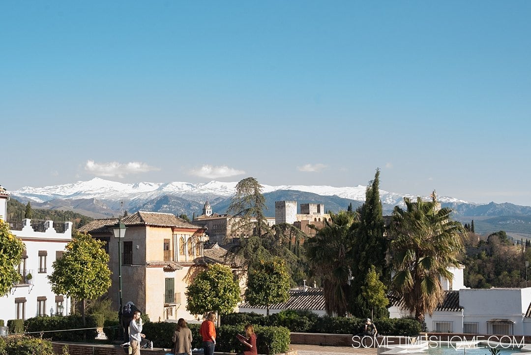 One Perfect Day in Granada Spain. Photos and itinerary on Sometimes Home travel blog. Picture of the snow capped mountain view from Placeta Cristo Azucenas.