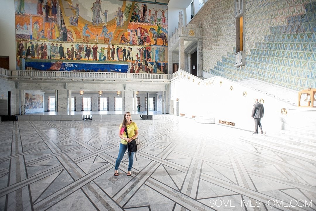 10 Not-to-Miss Sites in Oslo Norway by Sometimes Home travel blog. Photo of the colorful interior of Oslo Radhus, City Hall.