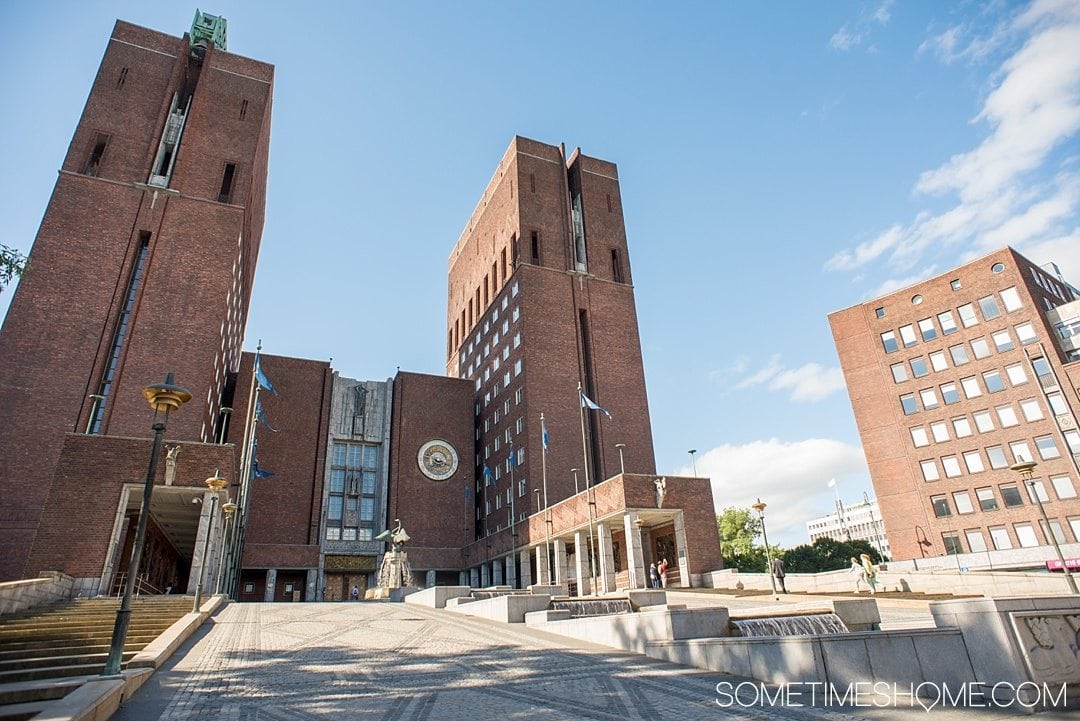 10 Not-to-Miss Sites in Oslo Norway by Sometimes Home travel blog. Photo of the brick exterior of Oslo Radhus, City Hall.