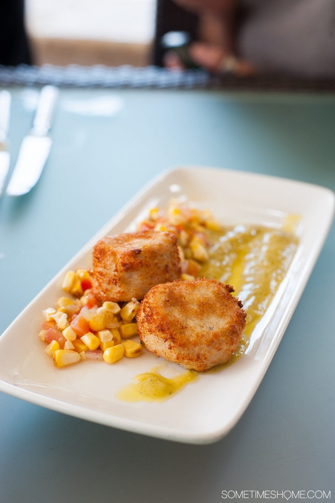 Your Questions Answered: Jade Mountain St. Lucia on Sometimes Home travel blog. Photo of crabcakes and a corn relish at Jade Mountain Club.