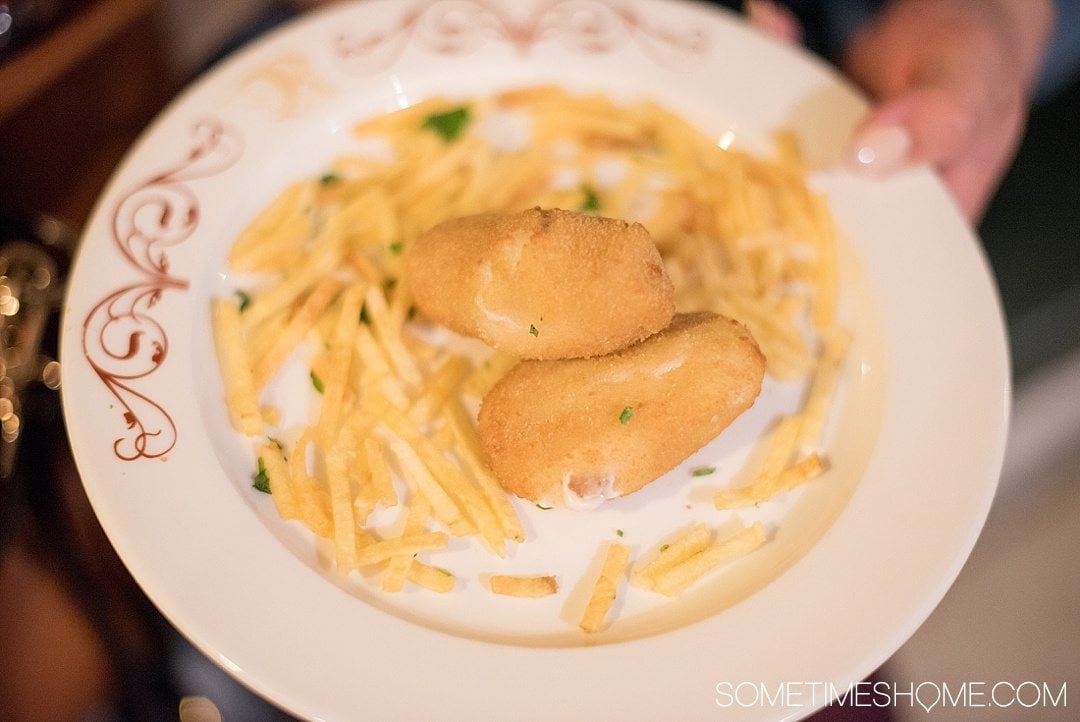Eat Your Way Through Seville on Sometimes Home travel blog. Photo of croquettes and french fries.