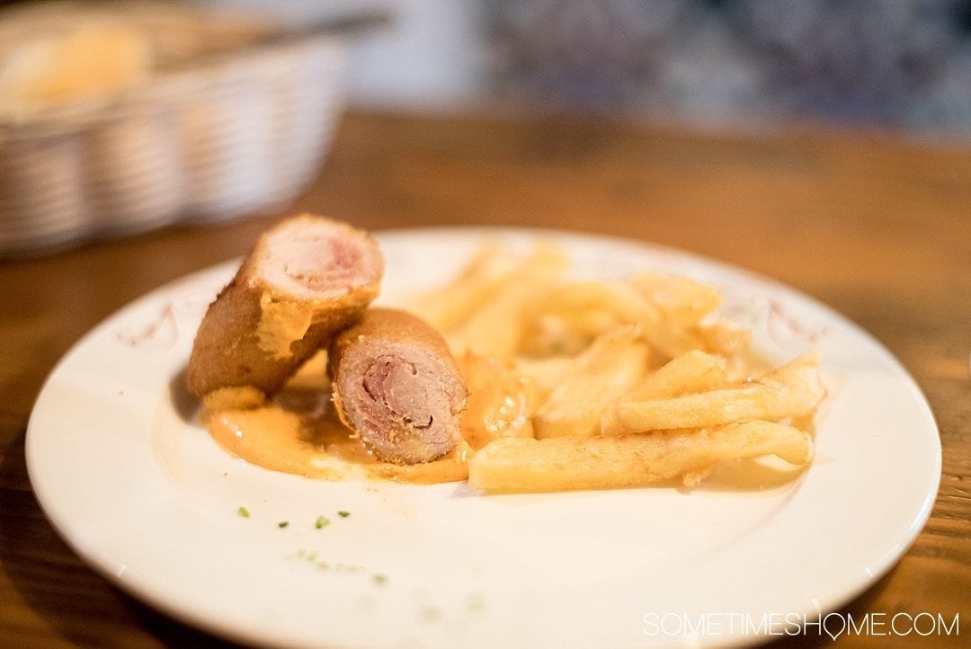 Eat Your Way Through Seville on Sometimes Home travel blog. Photo of flamenquin and french fries.