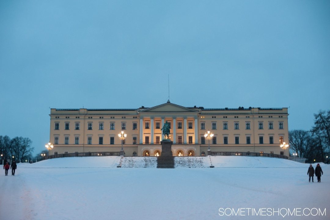 Reasons Why January is the Best Time to Visit Norway with a photo of the Royal Palace in Oslo covered with snow.