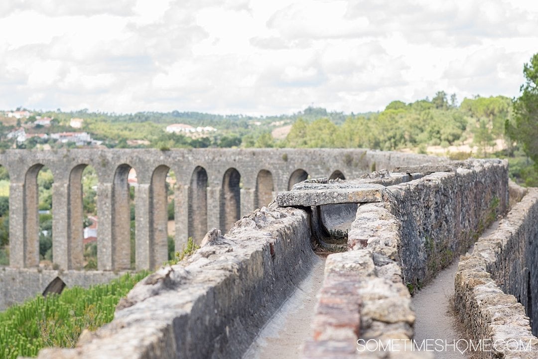 Day trip to Tomar, Portugal from Lisbon. Photos, tips and advice on Sometimes Home travel blog. Picture of Pegoes Aqueduct.