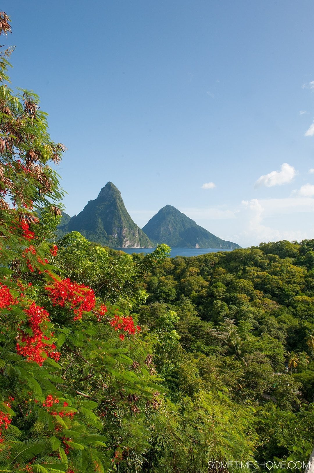 Must Do Activities to Revel In on Vacation in St. Lucia on Sometimes Home travel blog. Photos of the Piton mountains where you can hike and enjoy the view.