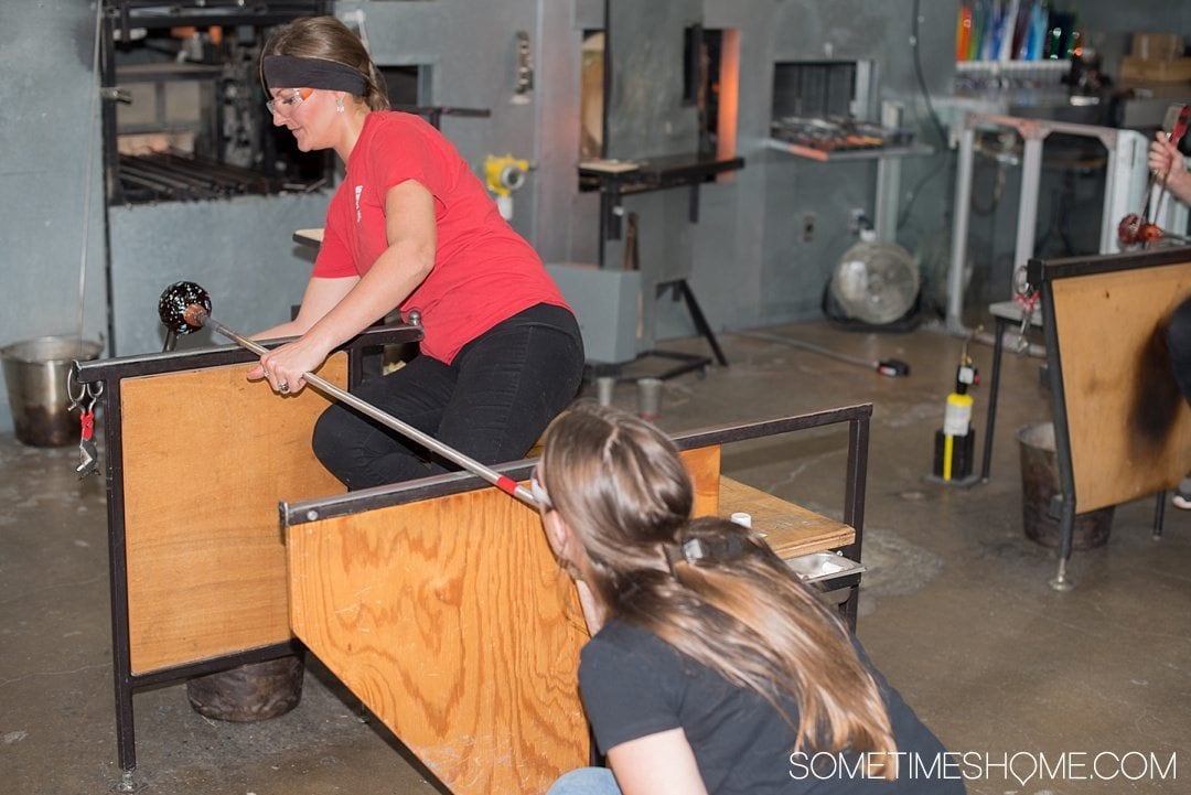 Corning Museum of Glass gift shop, hours, exhibits, photos and more on Sometimes Home travel blog. Also links to an article of what to do in Corning, New York in the Finger Lakes region. Picture of creating your own glass piece.