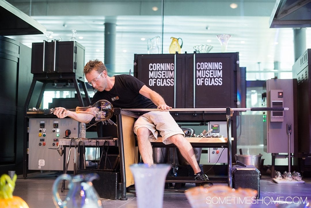 Corning Museum of Glass gift shop, hours, exhibits, photos and more on Sometimes Home travel blog. Also links to an article of what to do in Corning, New York in the Finger Lakes region. Picture of a demonstration of glass blowing.