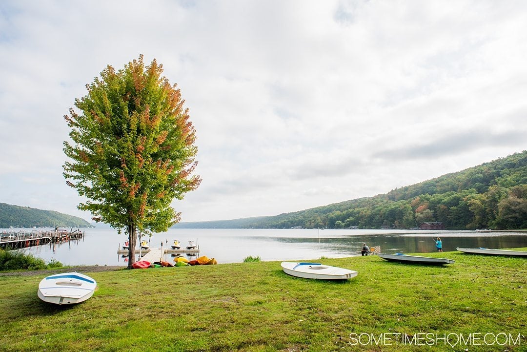 Things to do in Corning NY in the Finger Lakes region on Sometimes Home travel blog. Photo of Keuka Lake kayaking and paddle boarding.