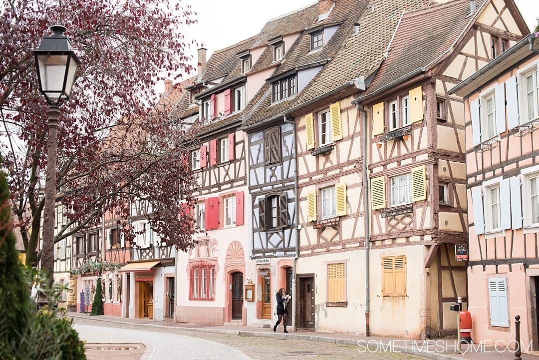 Photography of Colmar, France with scenery liken to Disney's Beauty and the Beast theatrical set design and scenery. These travel photos will inspire you to visit to this fairy tale location no matter if it's spring, winter or summer. Check out this beautiful place, including Little Venice, in this inspiring blog post! #AlsaceFrance #ColmarFrance #StorybookVillage