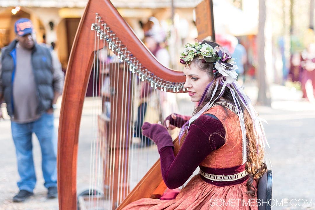 If you love theme parks and themed entertainment you'll love the North Carolina Renaissance Festival, associated with the Arizona location as well. Sometimes Home travel website has insider Q&A and information behind-the-scenes. Click through for pictures of the costumes and sets, food menu, drinks and beer, hairstyles, musicians, art and flower crowns and crafts! #RenaissanceFestival #VisitNC #NorthCarolianRenaissanceFestival #Renaissance #themedentertainment #sometimeshome #harp