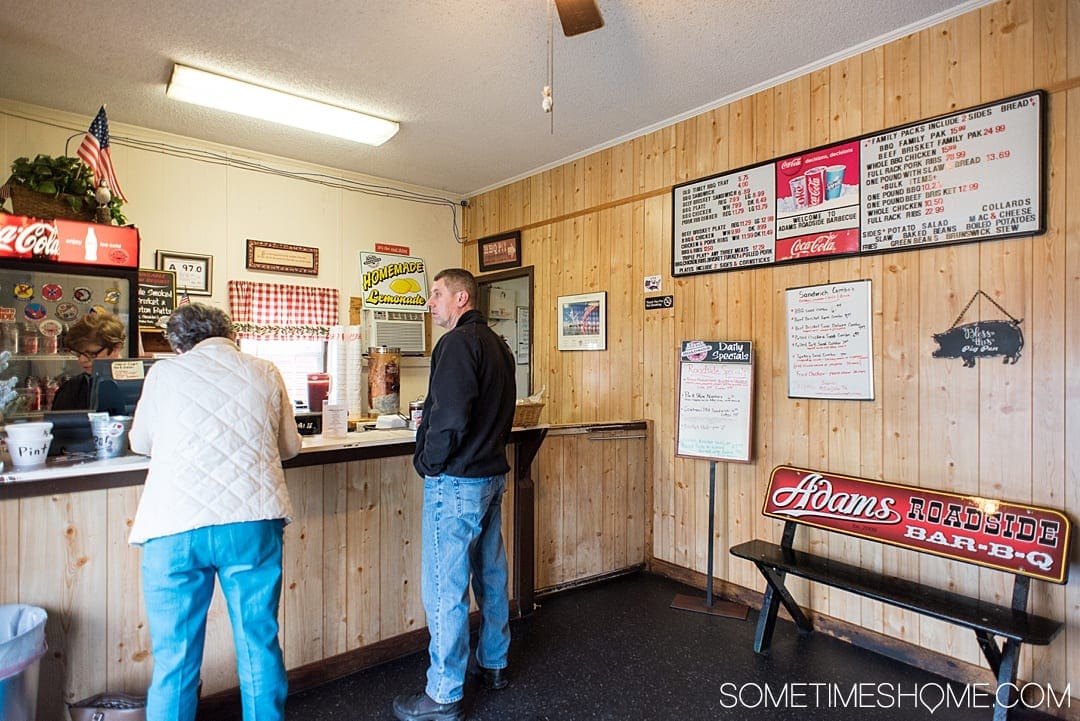 Goldsboro NC BBQ is a force to be reckoned with! The eastern vinegar based sauce of barbecue in this United States region can be sampled at a variety of restaurants, on pork, chicken, turkey or more. These restaurants have rubs to delight your taste too. Check out our article about the best places to try these southern delicacy recipes on delicious meats. #NCBBQ #barbecue #BBQ #northcarolina #GoldsboroNC #sometimeshome #vinegarBBQ #AdamsRoadside