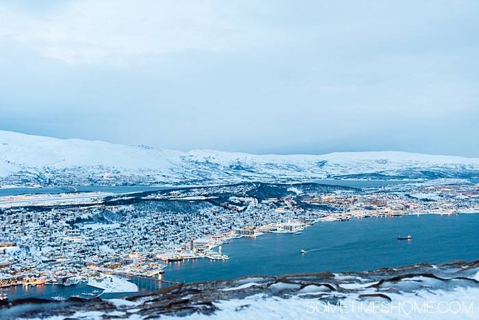 Tromso winter photos that will inspire you to travel to northern Norway during January or February. See bucket list things like Aurora Borealis (the Northern Lights), or participate in tours and things to do like feeding reindeer and taking a beautiful sleigh ride in the snow. #northernlights #sometimeshome #auroraborealis #reindeerfeeding #sleighride #tromsonorway #norway #tromsoinfebruary #tromsonorwayphotography