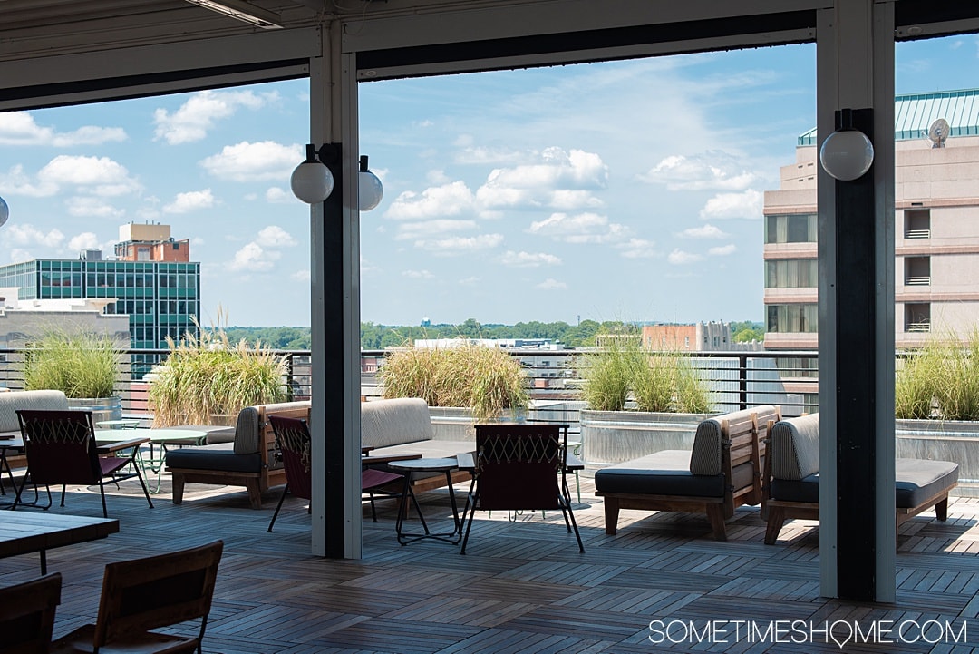 Downtown Durham, NC hotel decorated in Mid-Century Modern style. Check out photography of The Durham Hotel, the complete package. With a restaurant with James Beard Award Winning Chef, Rooftop Yoga with views of the skyline and great nightlife and cocktails. It's 30 minutes from Raleigh and a great staycation weekend getaway option too. #SometimesHome #MidCenturyModernHotel #RooftopBar #DowntownSkyline #DurhamNC #DurhamNorthCarolina