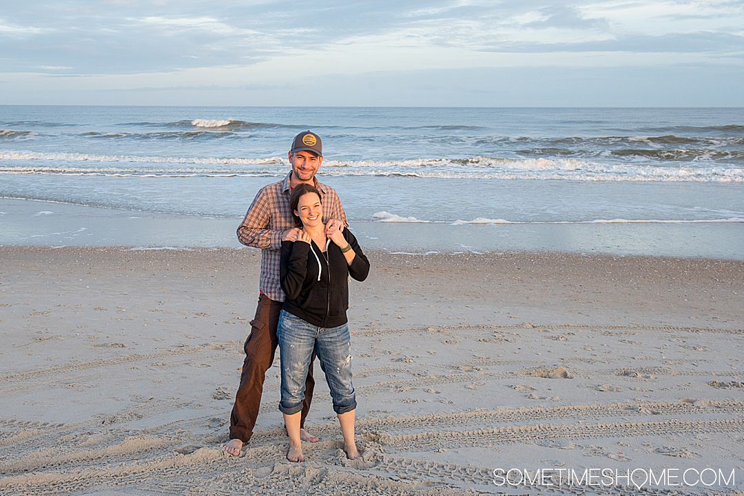 A couple on the beach as part of an article for affordable date ideas.