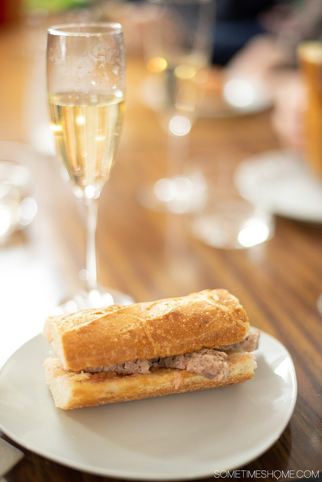 Spanish sandwich with meat (pork) and a glass of cava