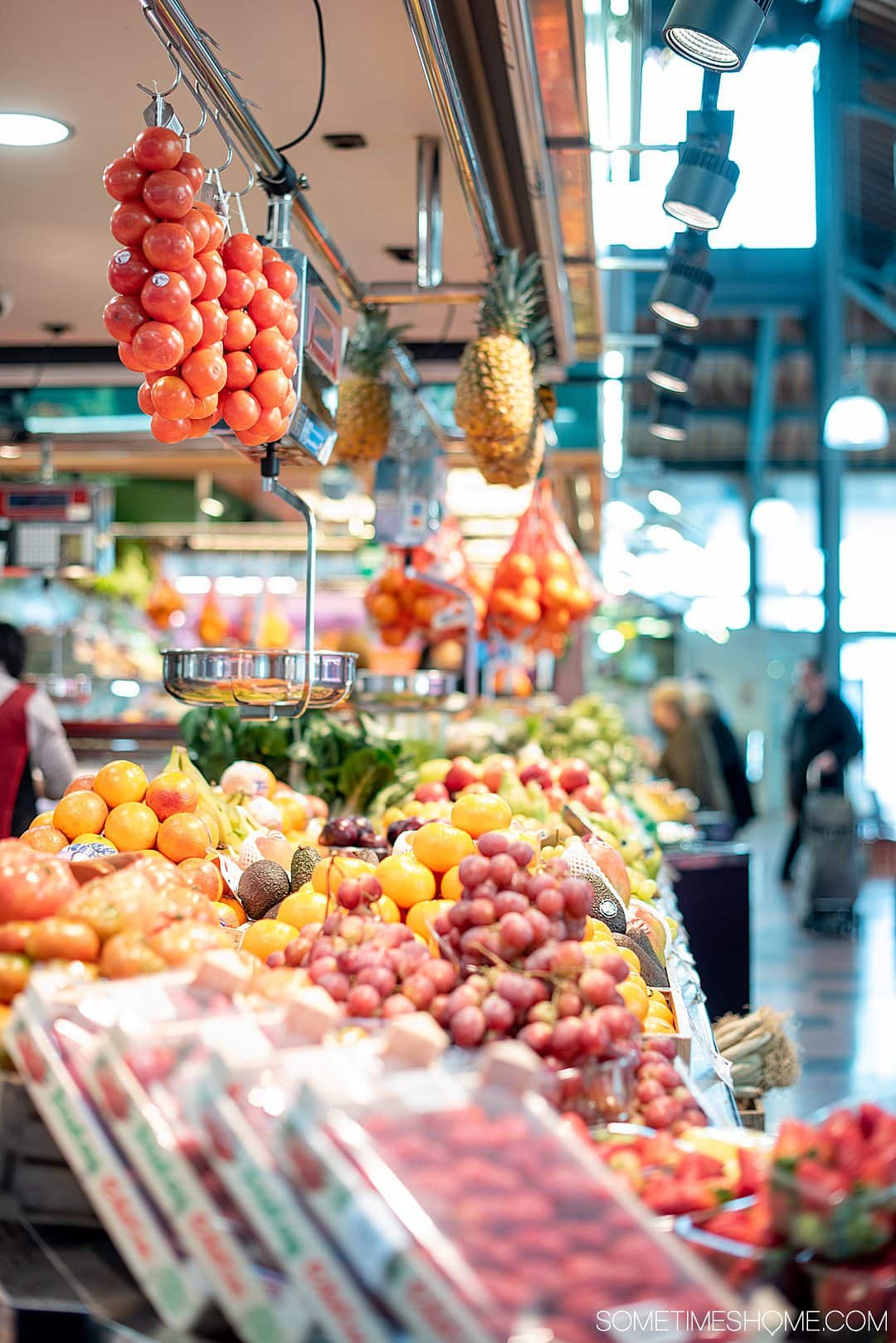 Hanging tomatoes and vegetables at a food market in Barcelona