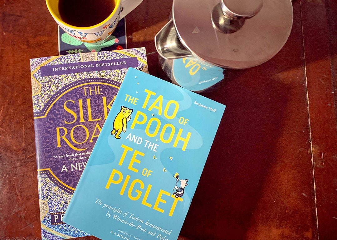 Tao of Pooh and Silk Road Books with tea.