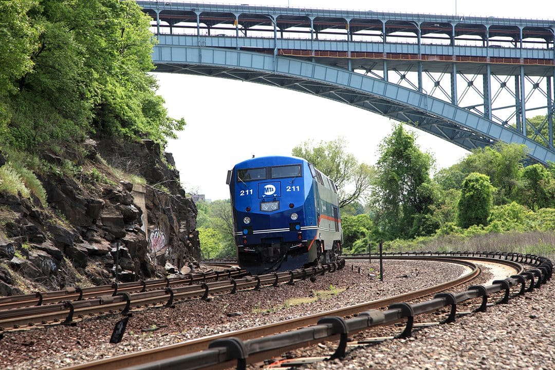 Blue train rounding the tracks.