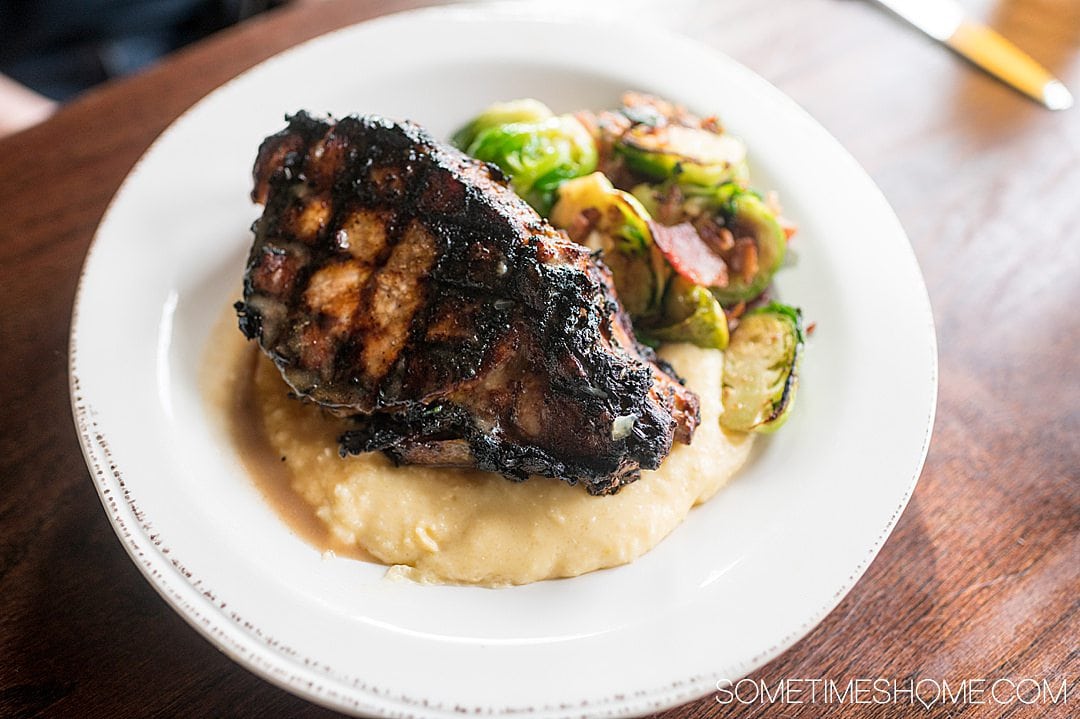 Pork chop, grits and Brussels sprouts dish at a York, PA restaurant