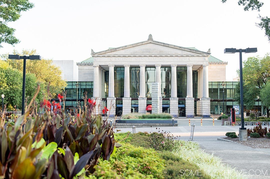 Building in downtown Raleigh with multiple columns and a triangle roof. Landscaping is in the foreground of the photo.