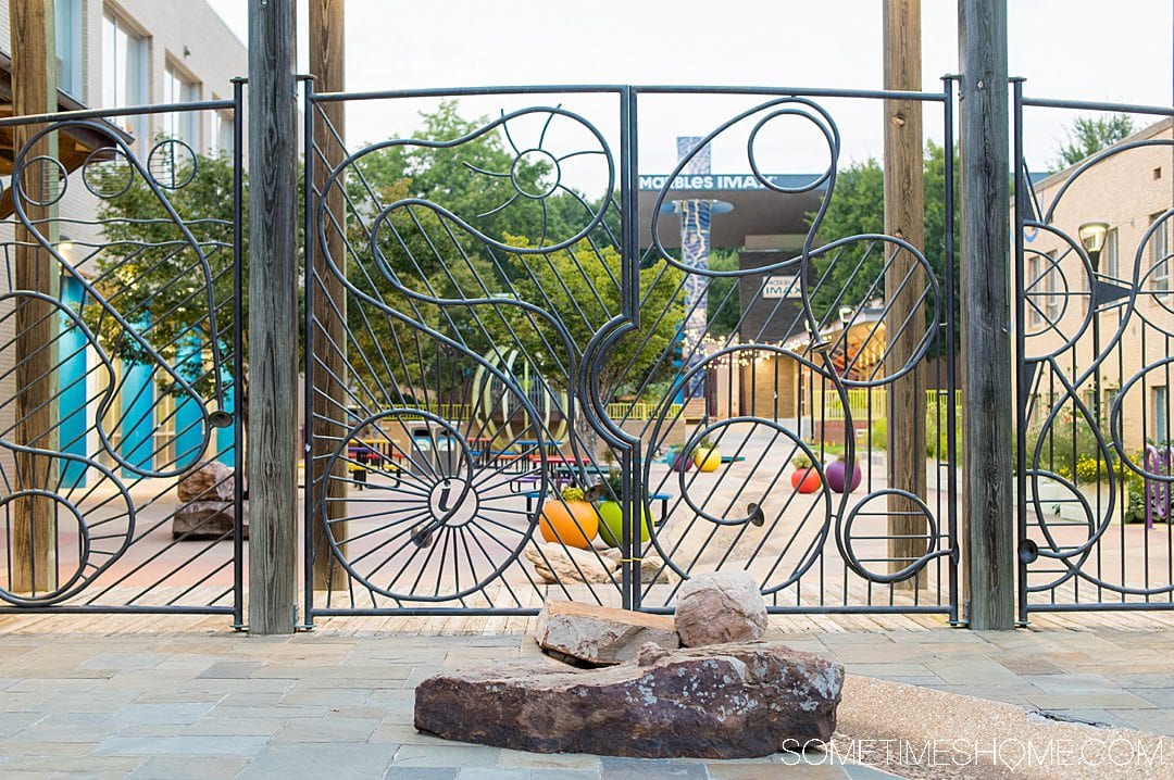 Whimsical iron gate and fence in front of the Marbles Kids Museum in downtown Raleigh, a great place to take pictures.