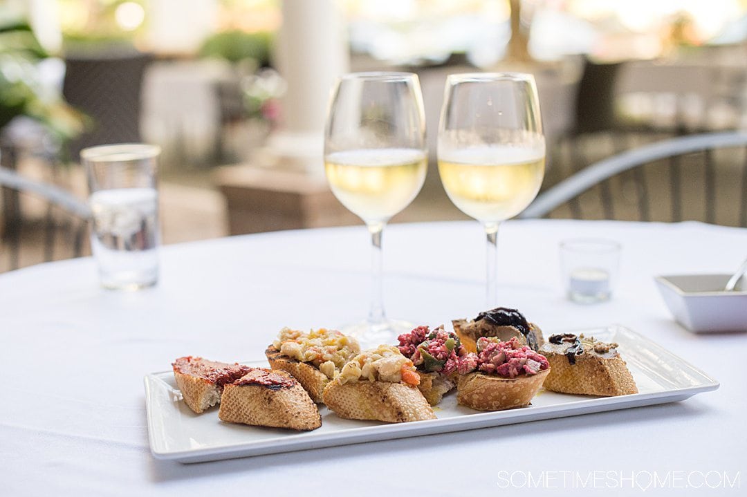 Plate of crostinis and white wine.