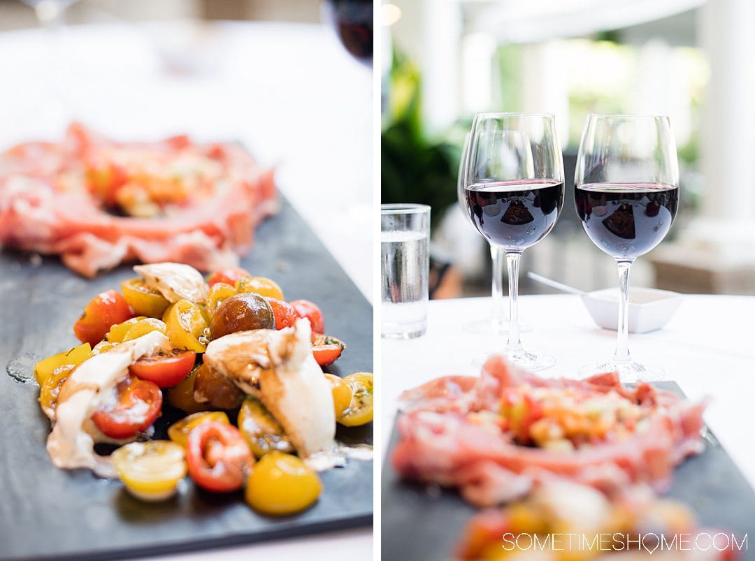 Plate of tomatoes and cheese with red wine.