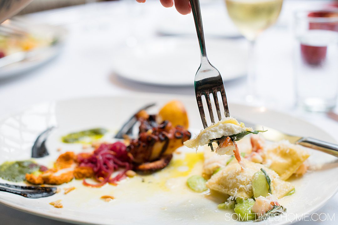 Plate of fresh burrata ravioli with lobster.