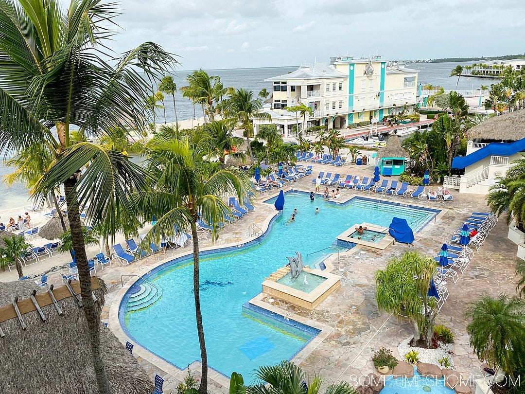 Aerial view of a blue pool in Key Largo, Florida with the bay in the distance.