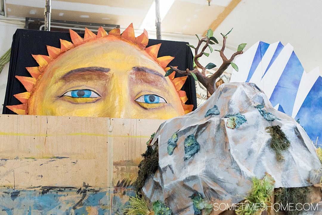 Paper mache sun peeking over to a mountain and tree