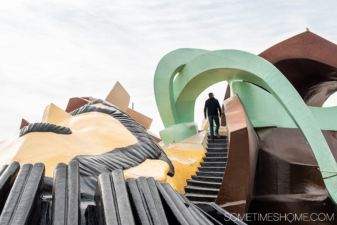 A playful photo of a man climbing stairs in a playground