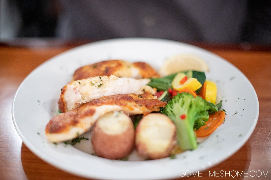 A plate of steamed vegetables and potatoes with parmesan crusted Grouper at Dinky's restaurant in Hatteras.