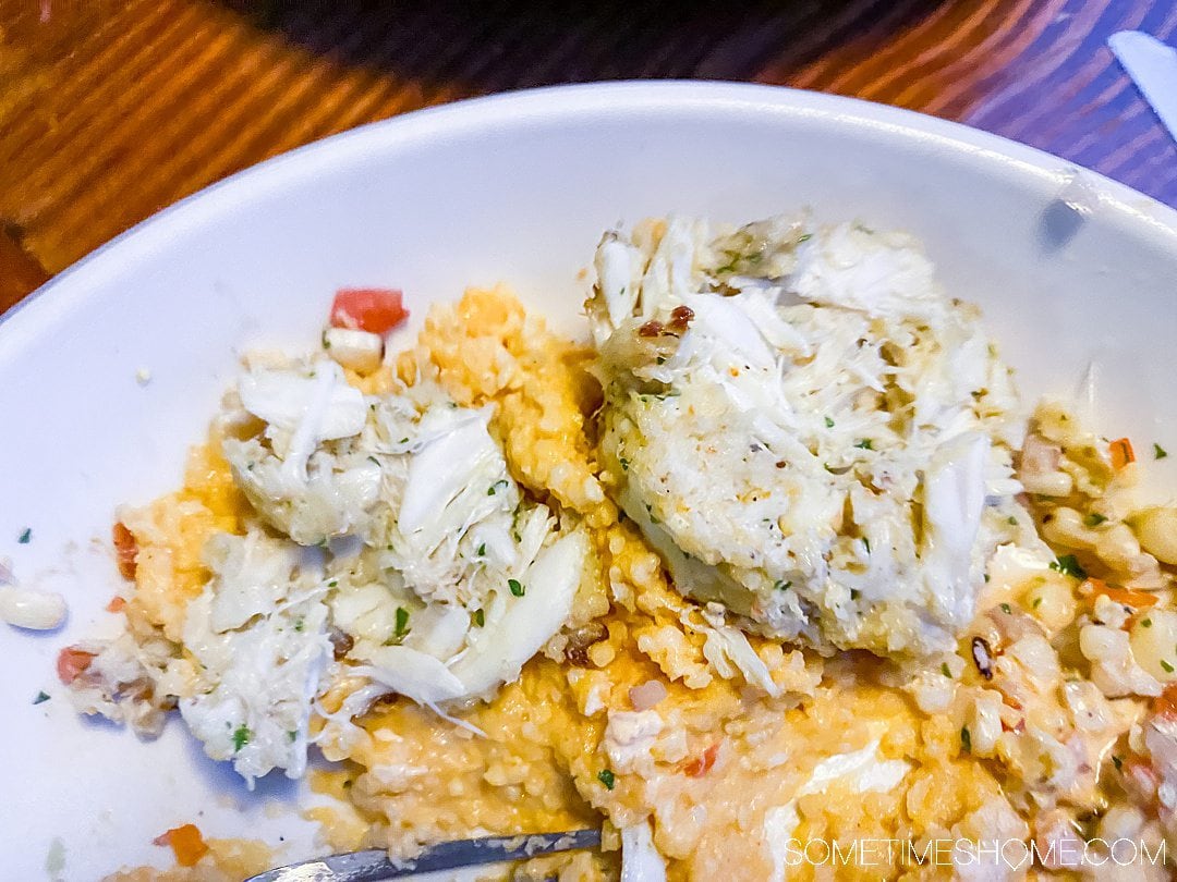 Lump crab cakes on top of cheesy grits at one of the best seafood restaurants in the Outer Banks.