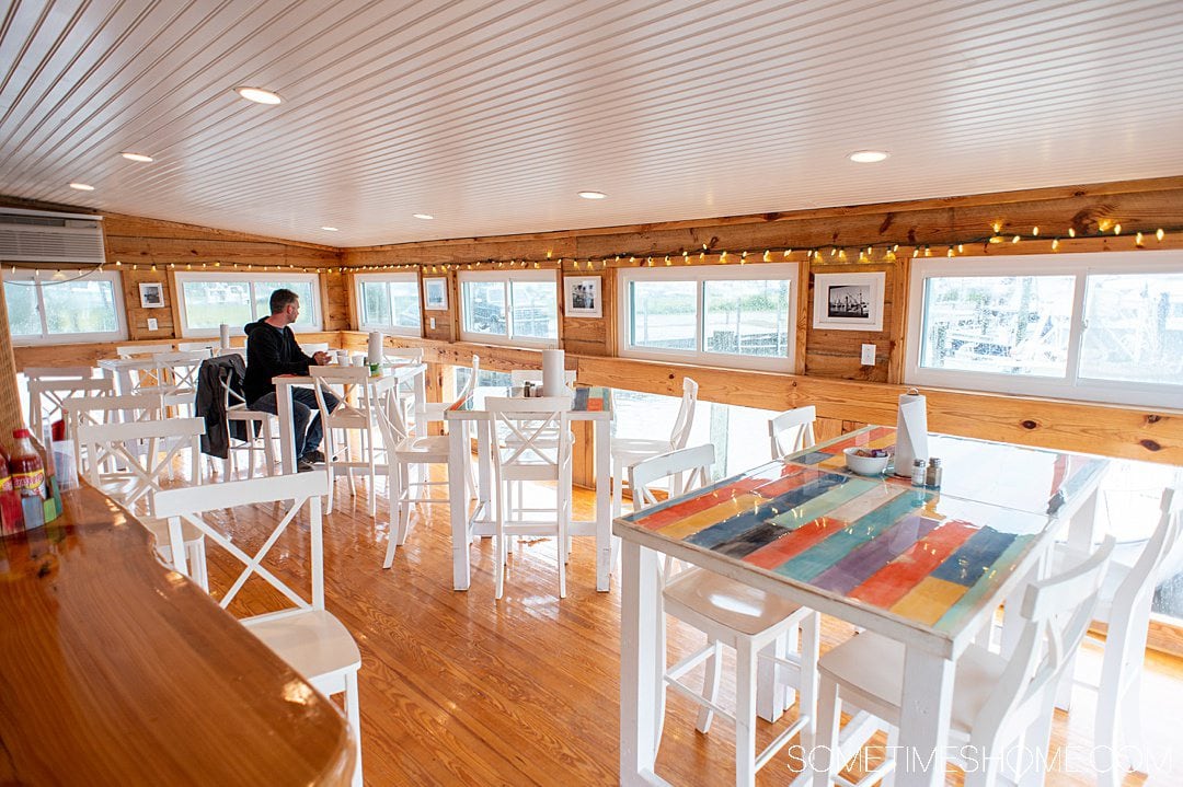 Colorful interior of a restaurant overlooking a marina in the Outer Banks, NC, at Wanchese Landing Grill & Marina on Roanoke Island.